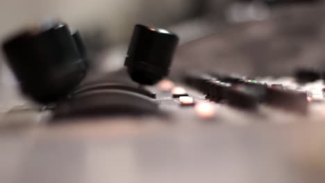 person operating an audio mixer