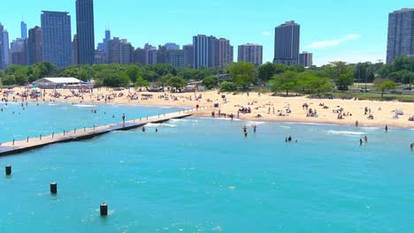 aerial flyby of north avenue beach in chicago illinois | downtown chicago in background