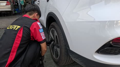 uniformed mechanic replacing a vehicle's tire swiftly