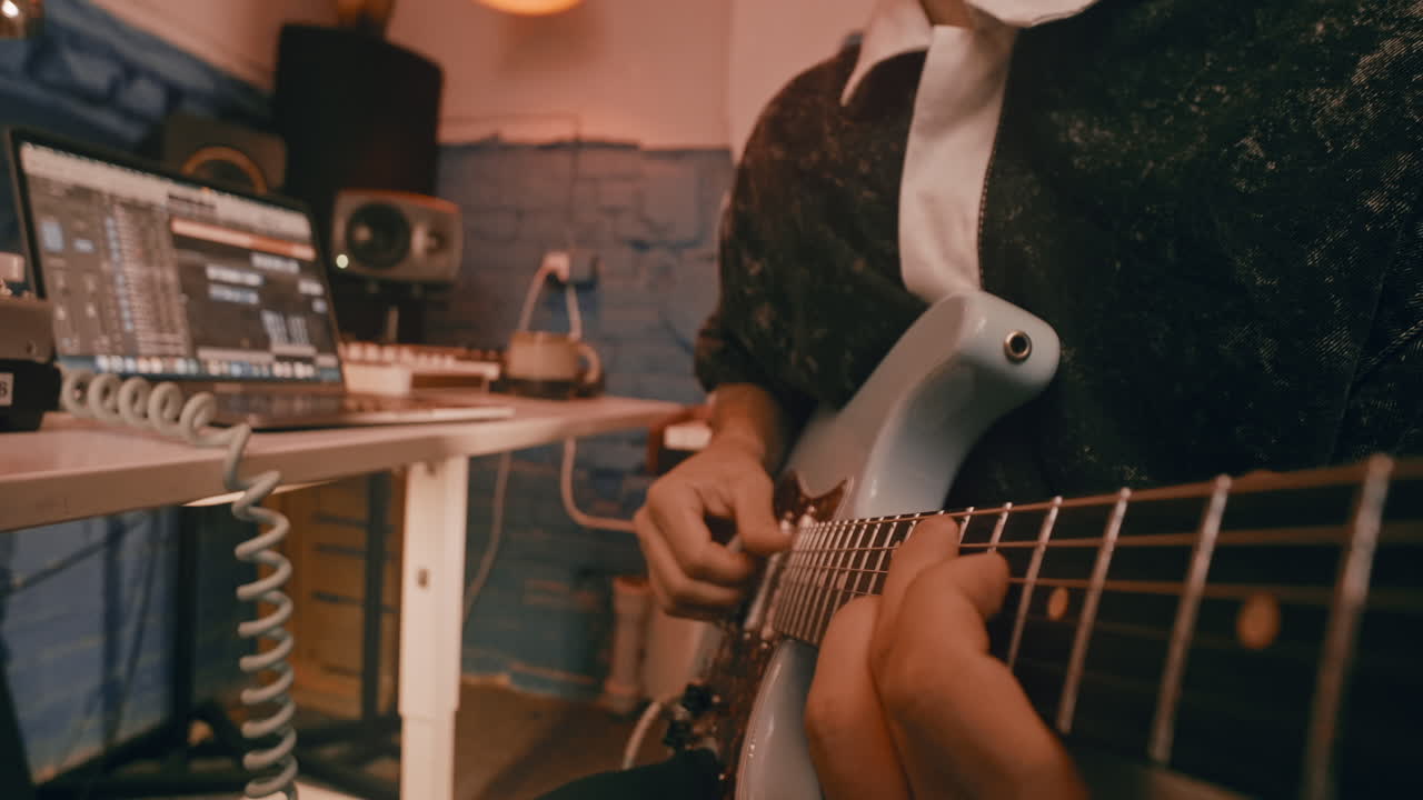 Musician Playing Electric Guitar in Home Recording Studio