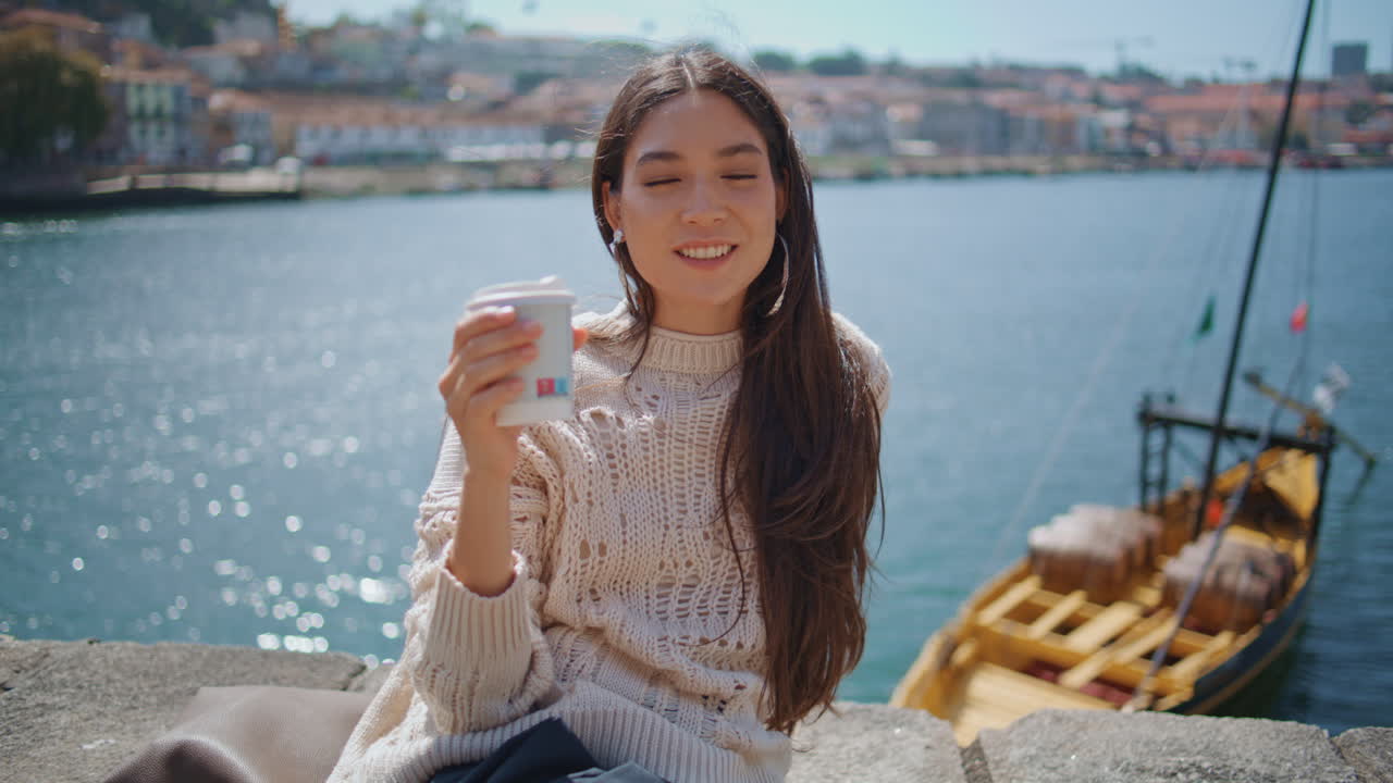 Portrait woman enjoying coffee in sunny european town. Tourist lady relaxing