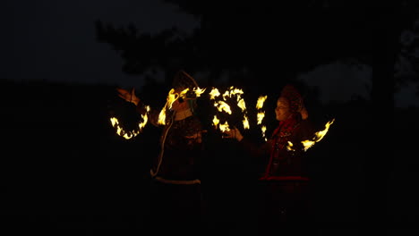 fire dancers at night