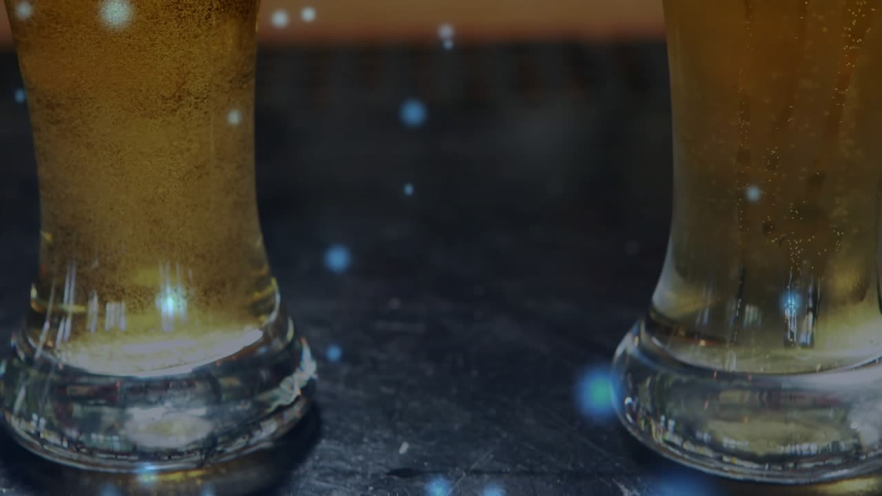 Camera pulling back revealing two tall beer glasses bubbles rising foam forming to show details
