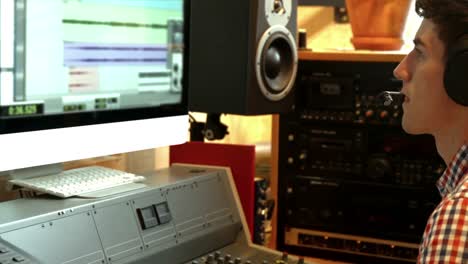 student mixing music in the studio