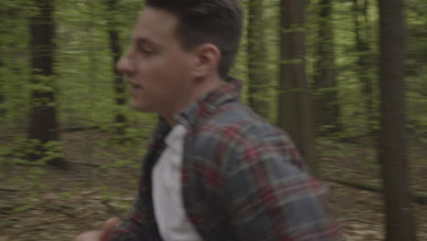 caucasian male running through the forest in slow motion