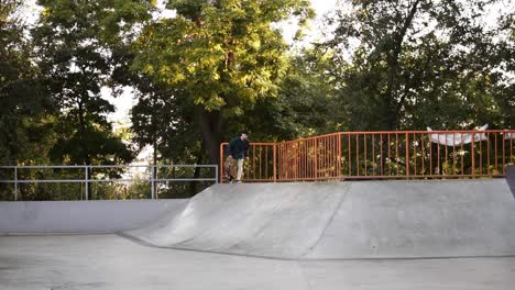 A-Skateboarder-Catching-The-Skateboard-While-Skateboarding-From-The-Ramp,-Balancing-In-The-Air-And-Landing-Slightly-On-The-Ground