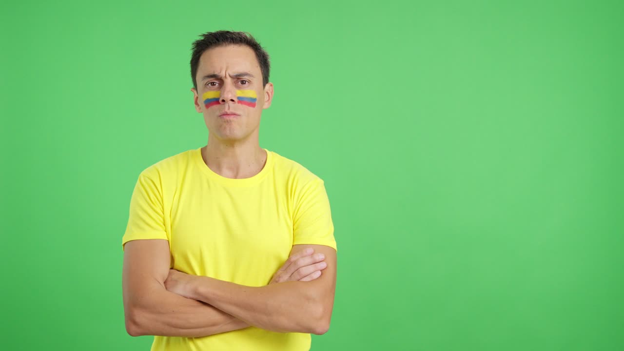 Dignified and serious man with colombian flag painted on face