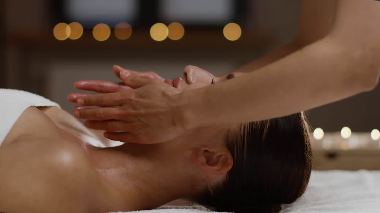 mujer recibiendo un masaje facial en un spa