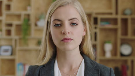 close up portrait of attractive young blonde business executive looking serious intimidating wearing suit pensive thoughtful