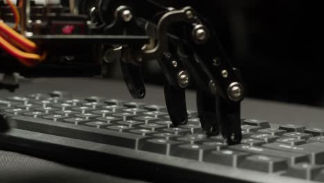 robot arm typing on a keyboard