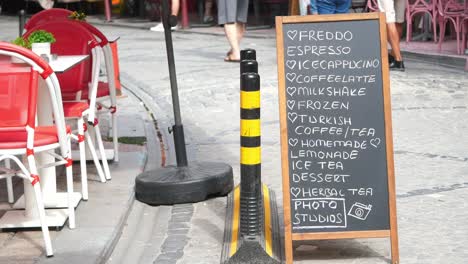 cafe menu board on a busy city street