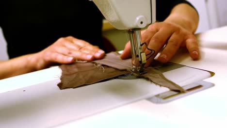 Seamstress-stitching-cloth-on-sewing-machine