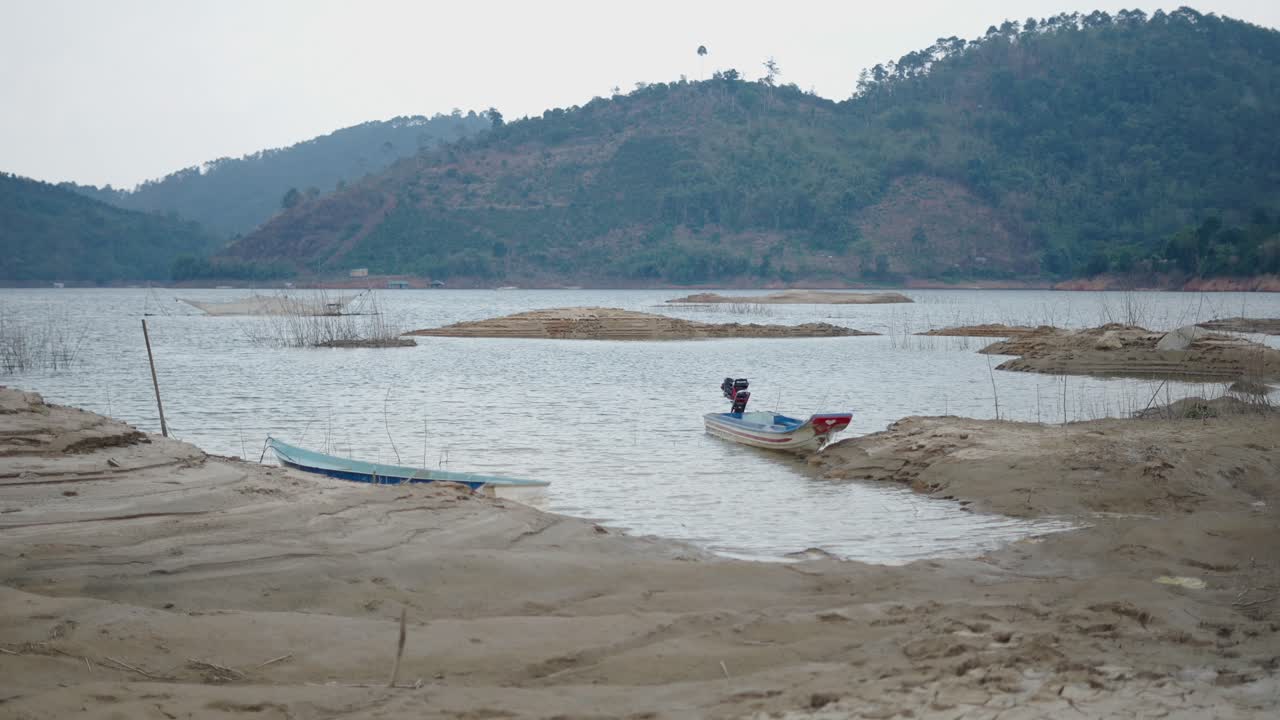 Mountain Lake with Boats during Low Water