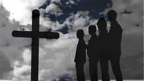 animation of silhouette of christian cross and a silhouette family of four