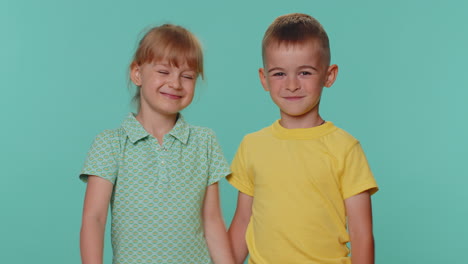 cheerful funny little toddler children boy girl siblings or friends smiling, looking at camera, hug