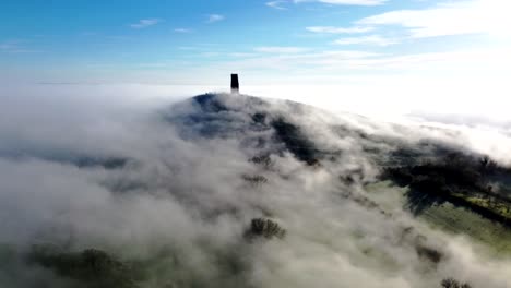 mist rolling over glastonbury tor, somerset, england