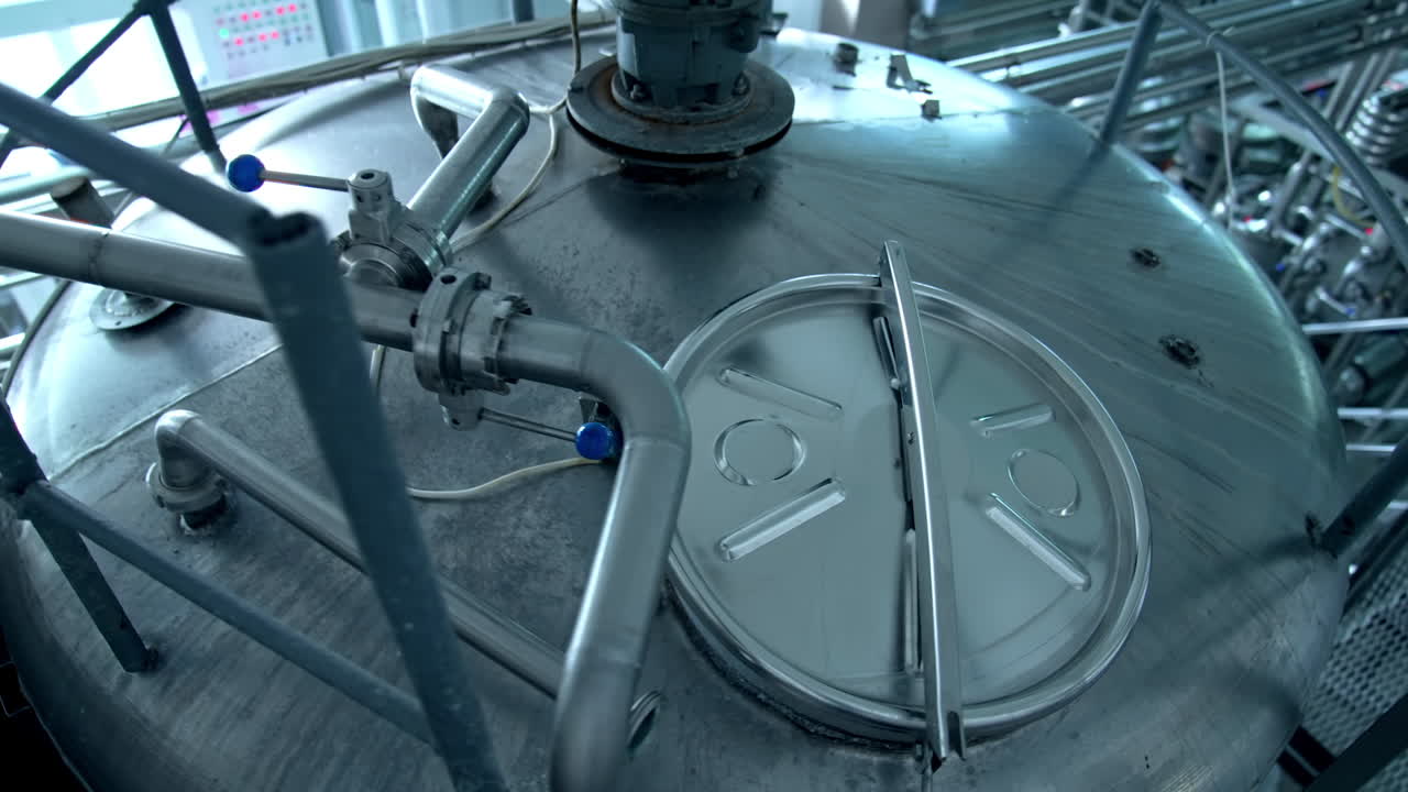 Stainless tank for milk production. Automated equipment on a milk farm. Modern industrial machinery for food processing. Top view.