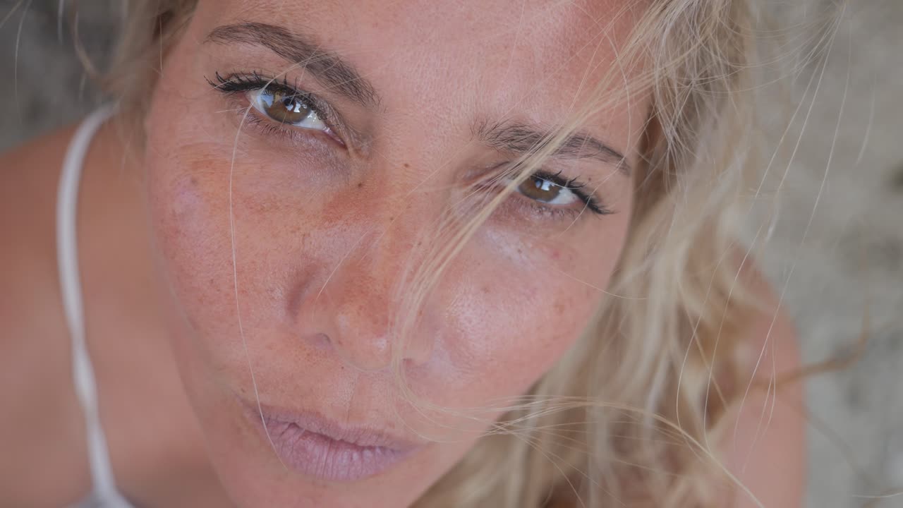 Close-up of a sad woman's face as she looks up to the sky