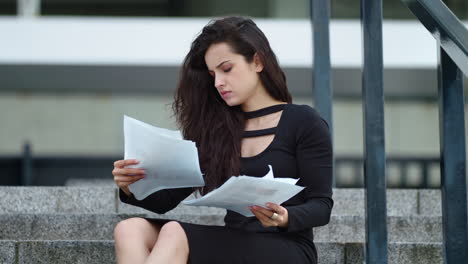 close up view of thoughtful woman analyzing documents outside