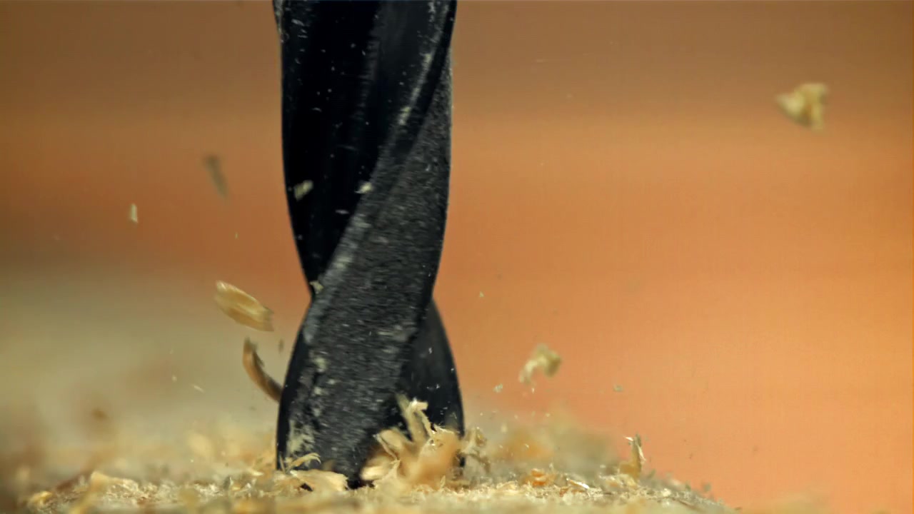 Close-up of a Drill Bit Drilling into Wood in Slow Motion