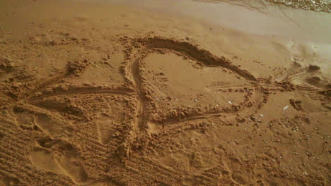 heart sand. heart draw on sand. heart shape on sand background