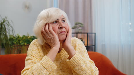 senior woman at home suffers from unfair situation problem break up depression bad sick ill annoyed
