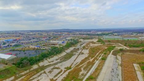 drone footage showing flood plain area and stores with high way in the distance