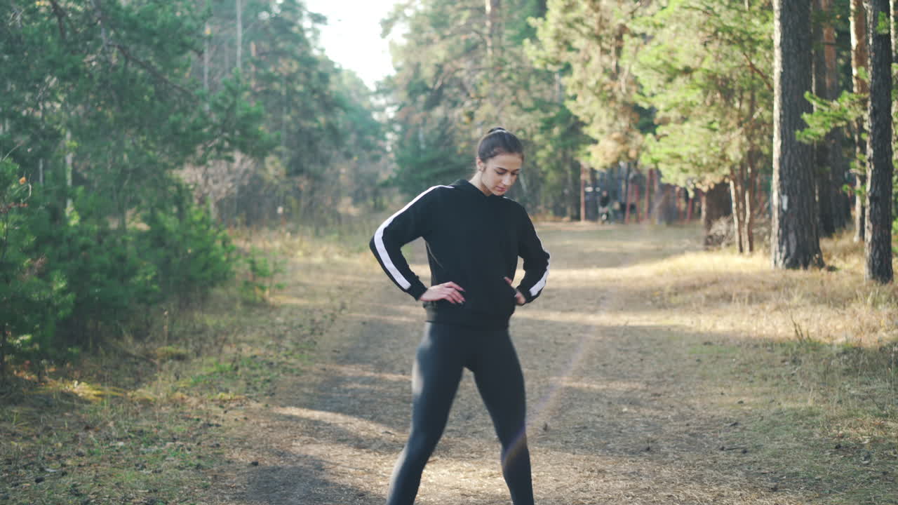 Woman stretching outdoors in a forest
