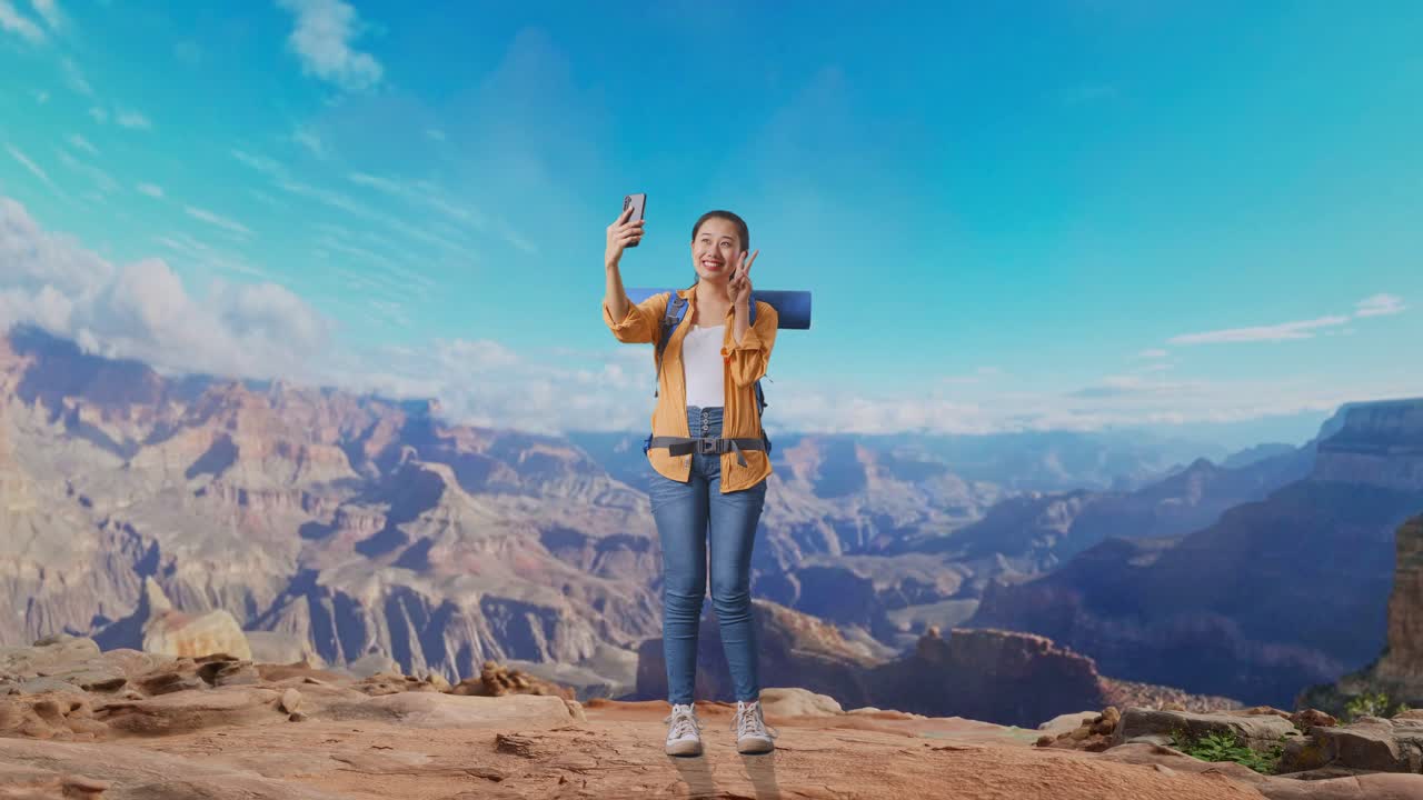 Full Body Of Asian Female Hiker With Mountaineering Backpack While Taking A Selfie While Traveling At The Top Of Mountain