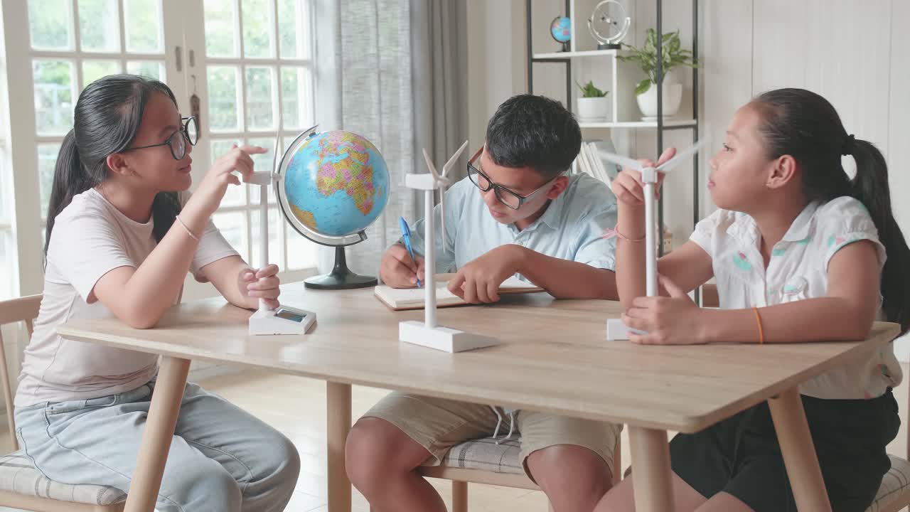 Asian Group Of Thoughtful Kids Study About Ecology Problems And Their Solution With Wind Turbine Model And Globe At School. Renewable Energy
