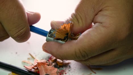 Footage-of-hands-slowly-sharpening-a-pencil-and-some-coloured-pencils-with-a-Wedge-Pencil-Sharpener