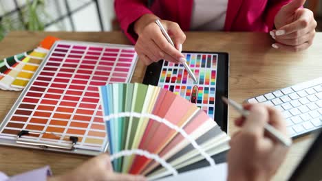 designers collaborating on color selection with swatches and tablet