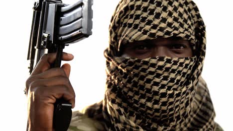 terrorist holding machine gun against white background