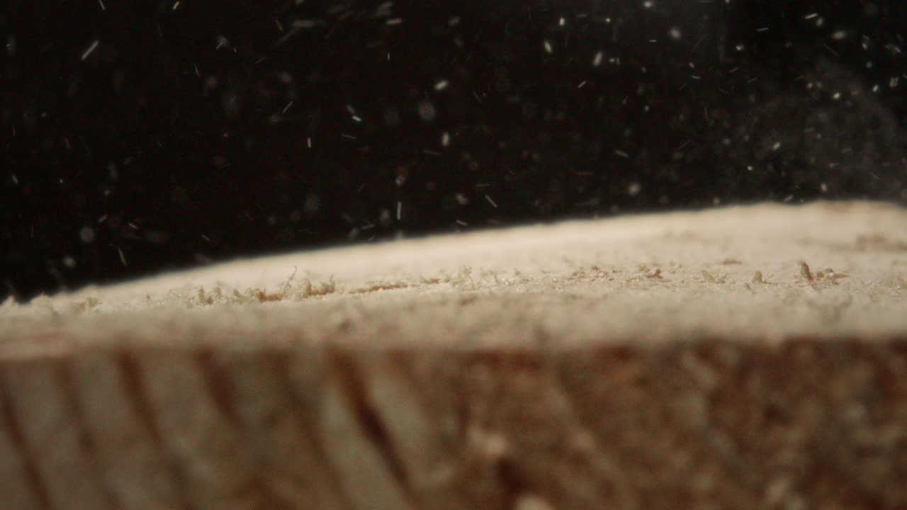 Close Up of Hammer Striking Screw Head on Wooden Surface in Workshop