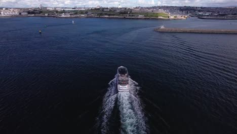 luxury boat sailing into the plymouth hoe in devon with scenic aerial views from above