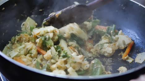 stir-fried vegetables in a wok