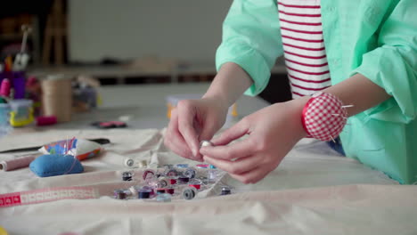 dressmaker choosing color of thread.