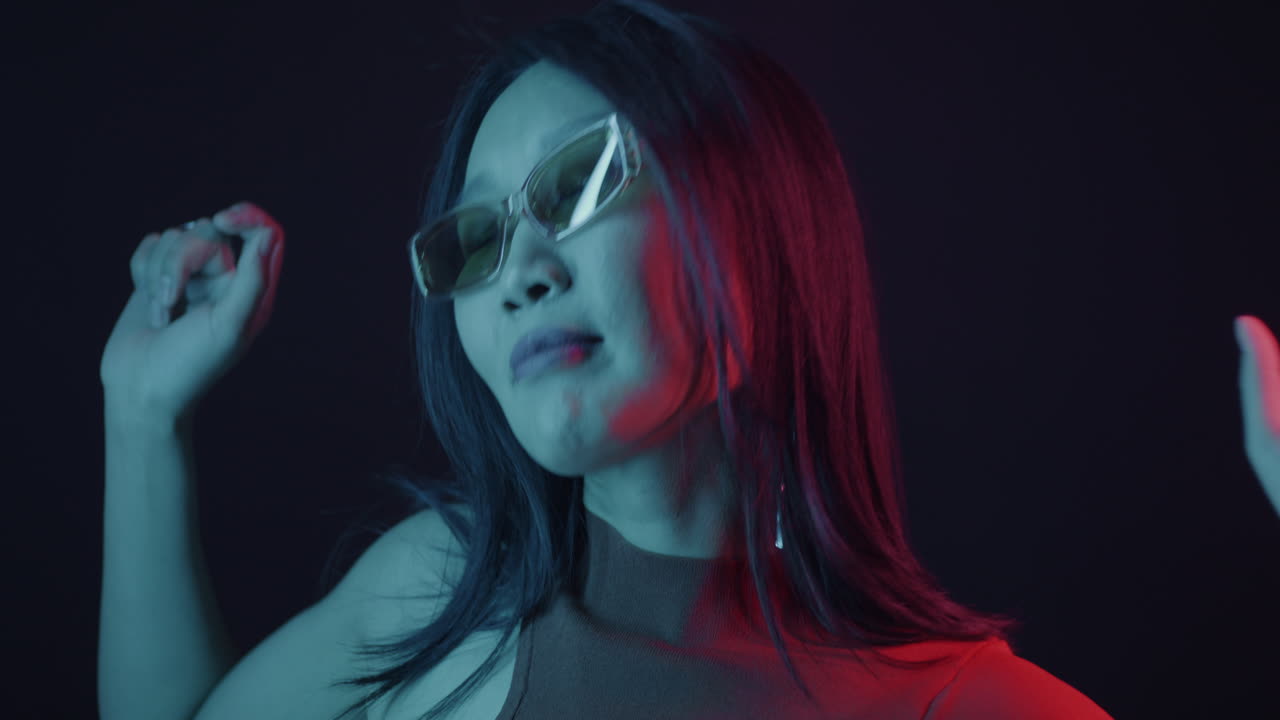 Stylish Woman Dancing Under Neon Lights