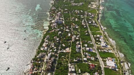 isla mujeres mexico aerial v1 birds eye view of a island located off the coast of cancun in the caribbean sea, surrounded by coral reefs and clear turquoise waters - shot with mavic 3 cine - july 2022