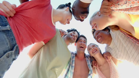 Diverse-group-of-friends-form-a-huddle-outdoors