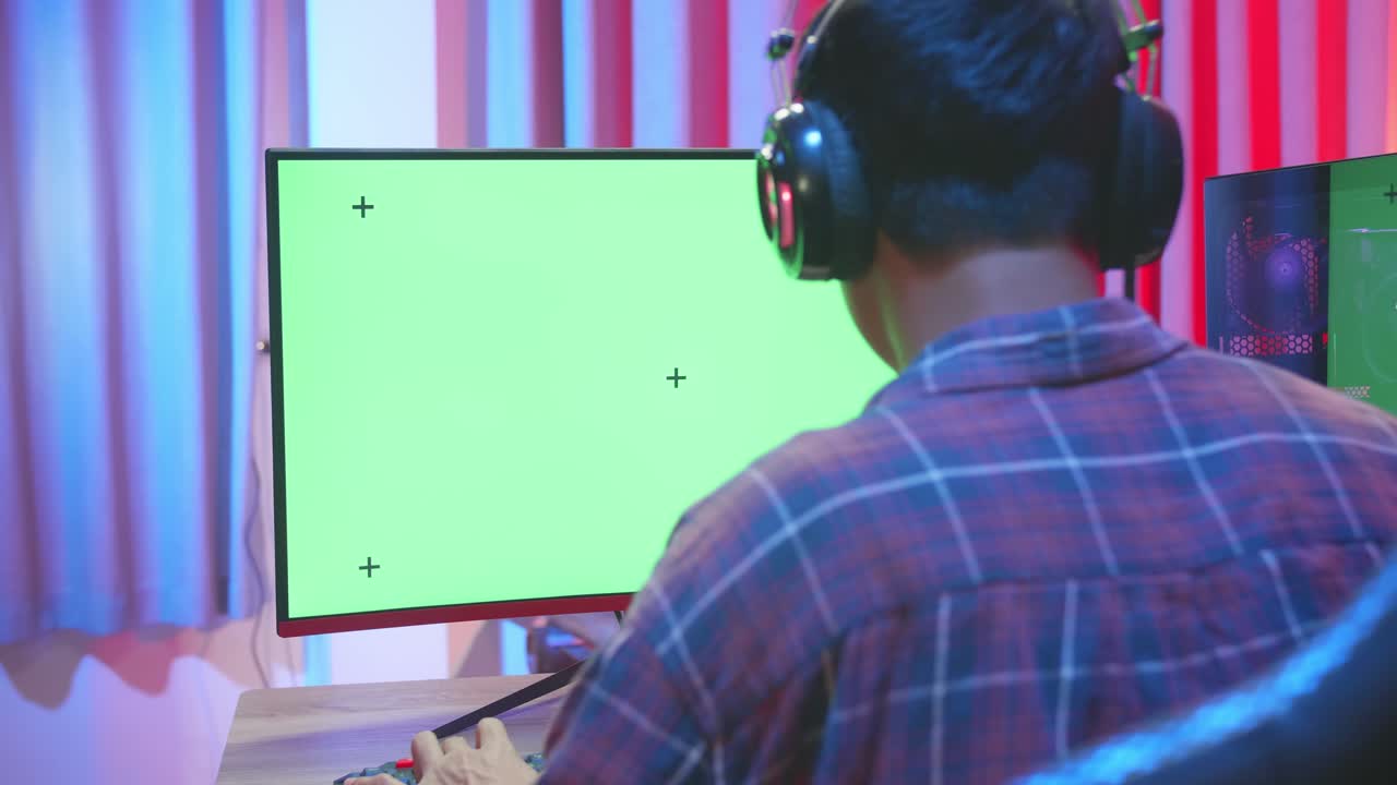 Man Gamer Playing Video Game With Green Screen Display