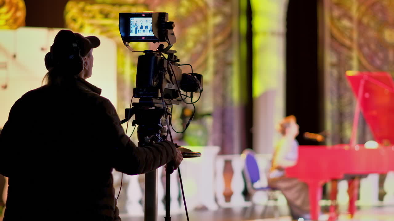 Man filming with professional camera on the backstage of a TV set