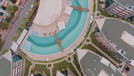 aerial view of a luxury resort complex with a swimming pool and apartment buildings.