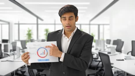 indian manager presenting a report in front of investors