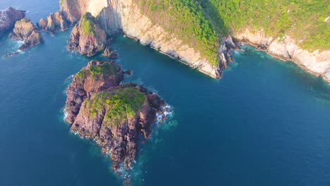 Flying-high-over-a-small-group-of-islands-next-to-a-large-piece-of-land-covered-in-jungle-and-greenery-near-Mexico