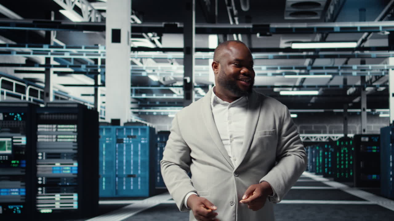 Vertical video Manager walking in high tech data center facility with rows of server racks