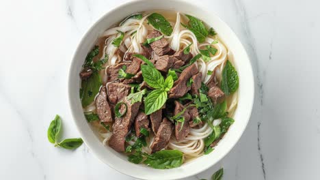 a bowl of vietnamese pho with beef and herbs