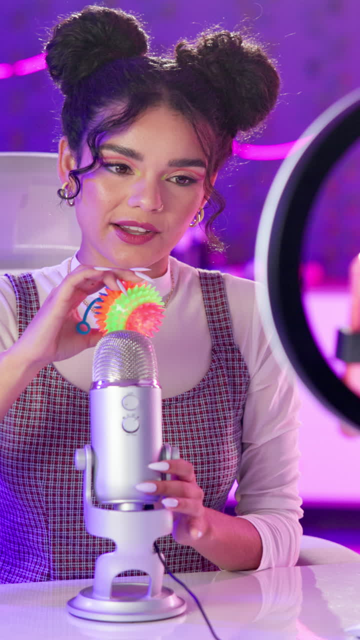 Woman recording audio with microphone and ring light