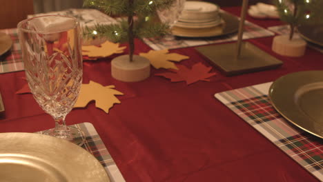 slide over festive holiday table towards gold plate place setting