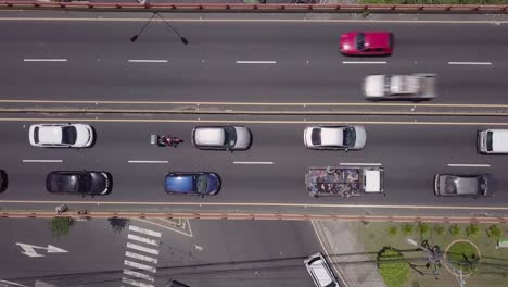 Satellite-view-of-traffic-on-a-roundabout-and-overpass-in-the-Soyapango-area-of-San-Salvador,-El-Salvador